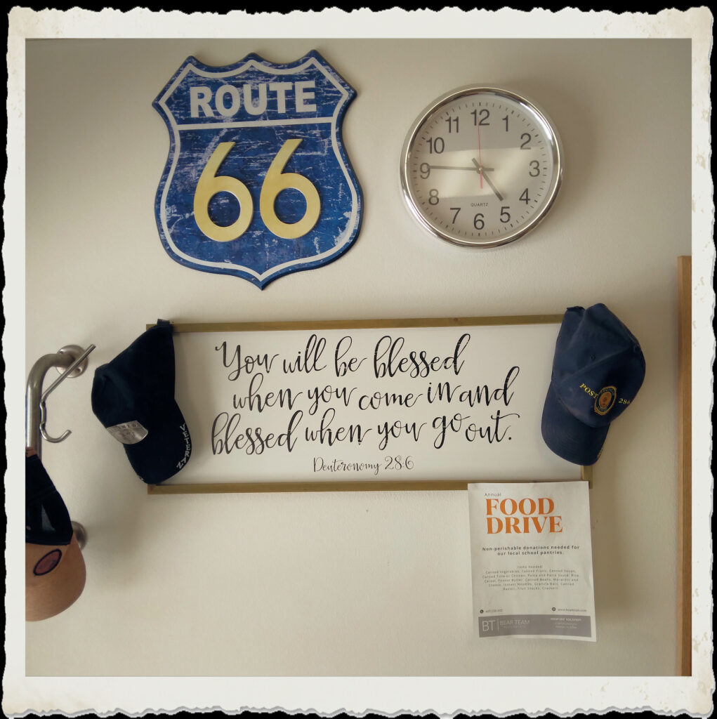 Vintage route 66 sign and blessing saying at Conway Village Barber Shop