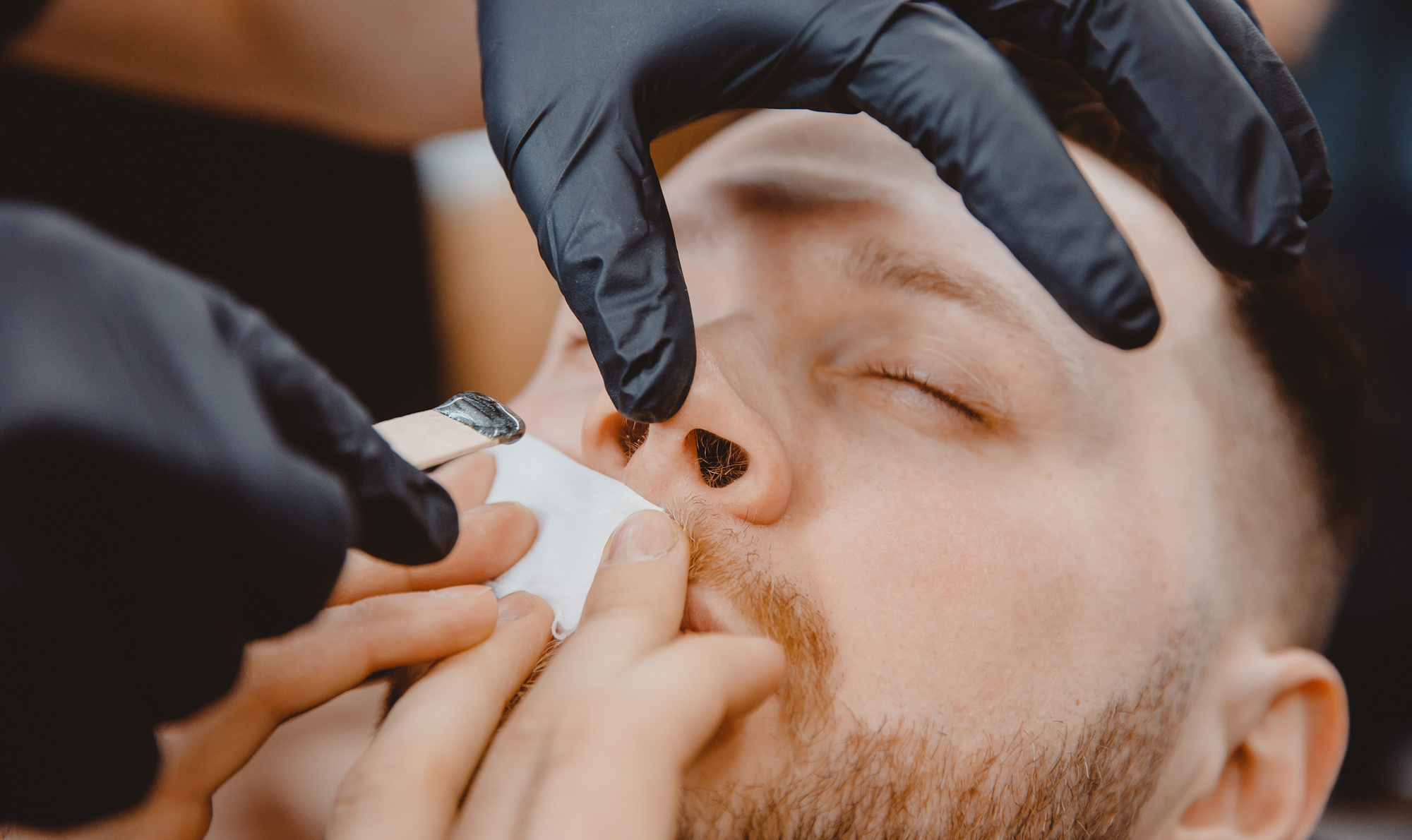 Nose waxing at a barbershop