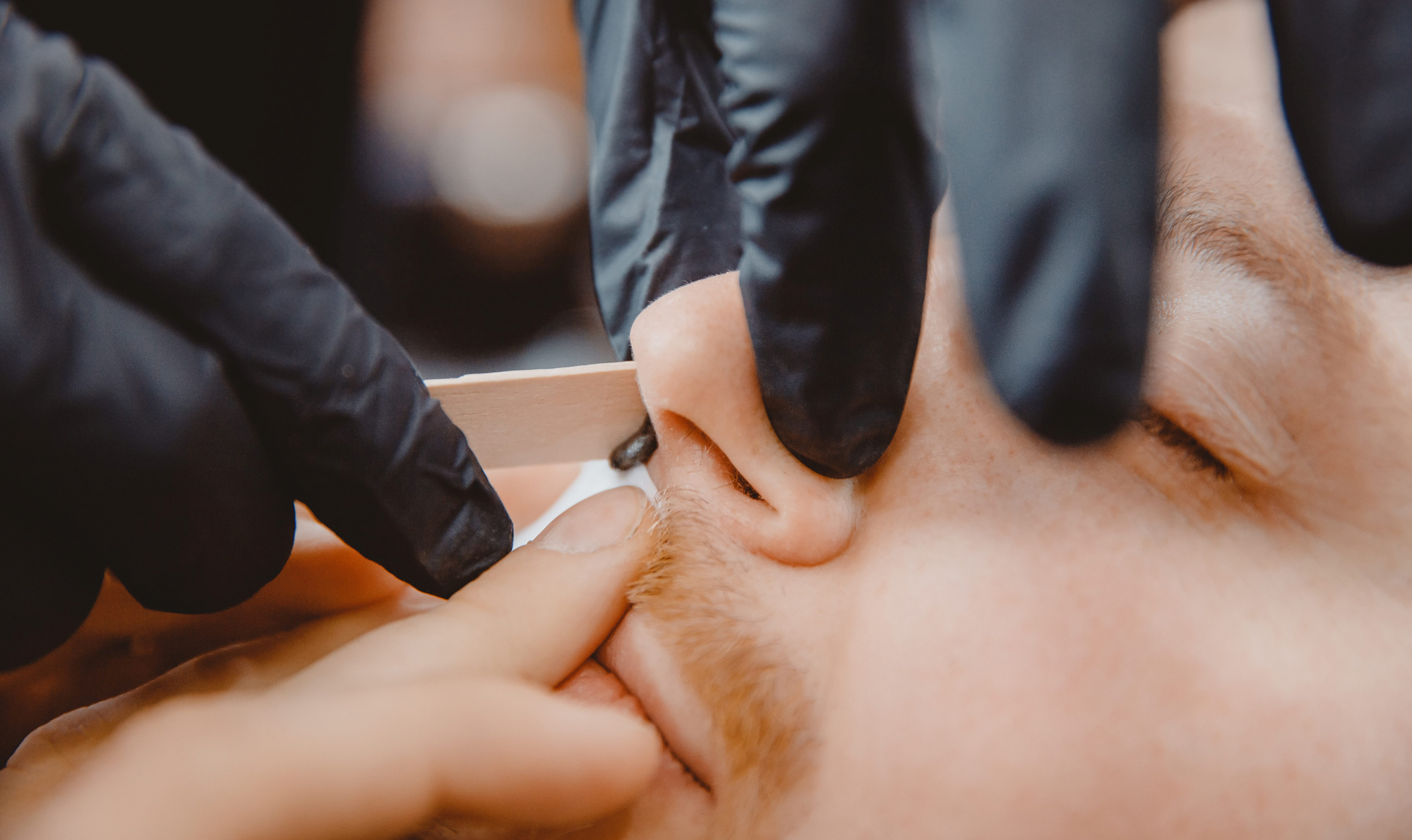 Nose waxing at a barbershop