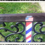 Patriotic American flag and barber pole bench outside Conway Village Barber Shop